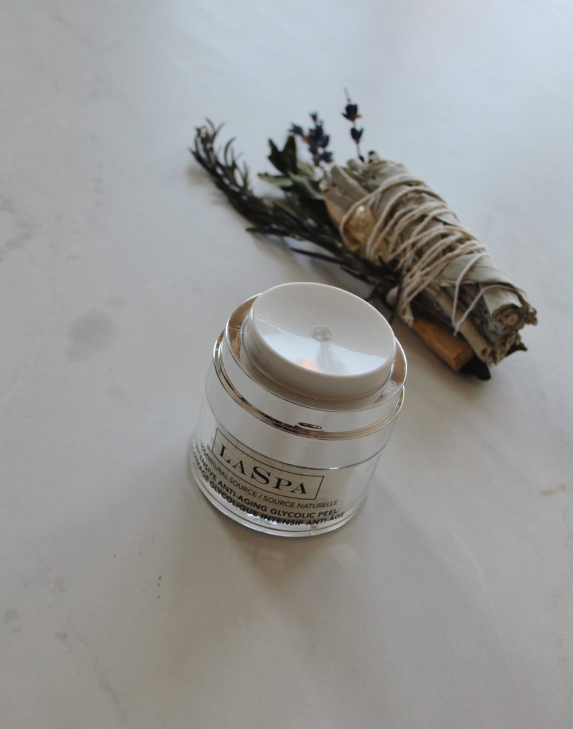 Beauty jar open showing the white lid that dispenses LASPA’s Glycolic Acid formulation with 3.5 pH balance, on a white marble counter
