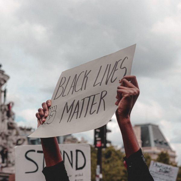 A person holding up a sign that says Black Lives Matter